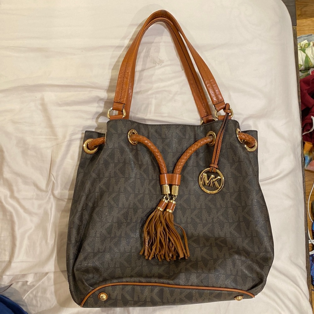 Used but great condition Michael Kors brown leather logo tote purse.